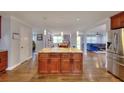 Spacious kitchen featuring wood floors, a large island with granite countertops, and open flow to other living areas at 2944 Berry Rd, Loganville, GA 30052