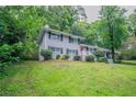 Charming two-story home with a landscaped yard and inviting red front door at 5795 Deerfield Trl, Atlanta, GA 30349