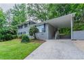 View of gray brick house with carport and well-manicured front lawn at 5795 Deerfield Trl, Atlanta, GA 30349