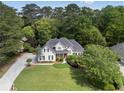 Charming two-story home boasts a lush green lawn and meticulously manicured landscaping at 1605 Little Lisa Ln, Snellville, GA 30078