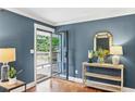 Bright entryway with hardwood floors, stylish console table and a modern glass door leading to the front porch at 185 Pamela Nw St, Marietta, GA 30064