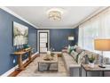 Stylish living room featuring hardwood floors, elegant decor, and a comfortable sofa with throw pillows at 185 Pamela Nw St, Marietta, GA 30064