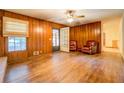 Cozy living room with wood-paneled walls, hardwood floors, and comfortable seating at 1850 Francis Sw Rd, Conyers, GA 30094