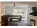 Inviting living room with a comfortable sectional sofa, sleek coffee table, and modern ceiling fan at 3796 Kensingwood Trce, Decatur, GA 30032