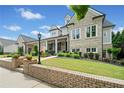 Attractive exterior showcasing a covered porch with columns, well-maintained landscaping, and brick accents at 487 Carmichael Cir, Canton, GA 30115