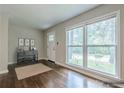 Sunlit living room with gleaming hardwood floors and a stylishly staged entryway, creating a welcoming atmosphere at 2509 Browns Mill Se Rd, Atlanta, GA 30354