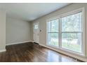 Bright living room featuring hardwood floors, a large window, and a crisp, clean aesthetic at 2509 Browns Mill Se Rd, Atlanta, GA 30354