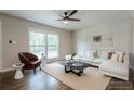 Contemporary living room with hardwood floors, a large window, and a stylish neutral color palette at 2509 Browns Mill Se Rd, Atlanta, GA 30354