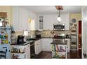 Bright kitchen with white cabinets, stainless steel appliances, and a stylish island with seating at 3606 Packhorse Run, Marietta, GA 30066