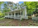 Inviting white home featuring a spacious front porch and a charming picket fence at 4112 Willow Sw Walk, Lilburn, GA 30047