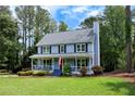 Beautiful two-story home with a cozy front porch and lush landscaping at 4994 Willow Creek Dr, Woodstock, GA 30188