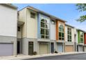 Street-level view of modern townhouses with garages and colorful accents at 1346 Peter Haughton Nw Way, Atlanta, GA 30318