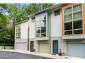 Eye-level of a townhome complex featuring colorful facades and ample green foliage at 1346 Peter Haughton Nw Way, Atlanta, GA 30318