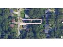 Aerial view of a property showcasing its location and surrounding neighborhood with mature trees and nearby street access at 241 Holly Nw Rd, Atlanta, GA 30314