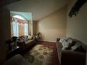 Comfortable living room featuring hardwood floors, natural light from the large window, and cozy sofas at 3393 Chancellors Dr, Powder Springs, GA 30127