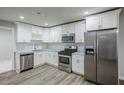 Bright kitchen featuring stainless steel appliances, white cabinets, and stylish subway tile backsplash at 3735 Boulder Park Sw Dr, Atlanta, GA 30331