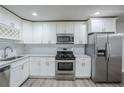 Well-equipped kitchen featuring stainless steel appliances, white cabinets, and subway tile backsplash at 3735 Boulder Park Sw Dr, Atlanta, GA 30331