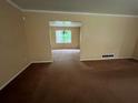 Open-concept living space with neutral walls, wall to wall carpet, offering a flexible layout for various furnishings at 765 Corundum Ct, Stone Mountain, GA 30083