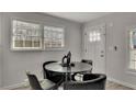 Cozy dining area with a round table, four chairs, and natural light at 874 Welch St, Atlanta, GA 30310