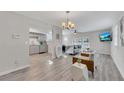 Open-concept living room with stylish decor, vinyl flooring, and a view of the kitchen at 874 Welch St, Atlanta, GA 30310