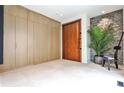 Light-filled foyer with wood accents, stone wall, large format tile flooring and custom millwork at 1572 Clifton Rdg, Atlanta, GA 30307