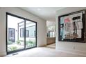 Bright hallway with a view to outdoor courtyard, showcasing modern art, and neutral decor at 1572 Clifton Rdg, Atlanta, GA 30307