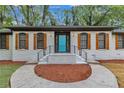Charming painted brick home featuring a blue front door and shuttered windows at 4576 Dorset Circle, Decatur, GA 30035