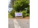 Community sign for Chauncey Creek neighborhood with lush green landscaping and street sign at 497 Natasha Dr, Auburn, GA 30011