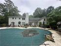 Lush backyard with a covered pool and patio space, perfect for outdoor entertaining at 3 Perthshire Dr, Peachtree City, GA 30269