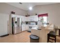 Bright eat-in kitchen features white cabinets, stainless steel appliances, and breakfast bar at 3130 Jorden Crest Ct, Lawrenceville, GA 30044