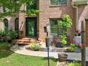 Welcoming brick home boasts a charming front entrance, manicured landscaping, and an inviting front patio at 5105 Tynewick Ne Trce, Roswell, GA 30075