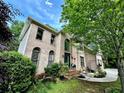 Stately brick home with large windows and a charming entrance with manicured landscaping at 5105 Tynewick Ne Trce, Roswell, GA 30075