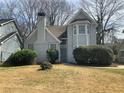Inviting home with bay windows, light-colored brick and lush landscaping at 76 Burbank Dr, Atlanta, GA 30314