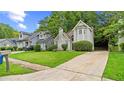 Two-story home boasts a well-maintained lawn and mature trees, creating a welcoming curb appeal at 76 Burbank Dr, Atlanta, GA 30314