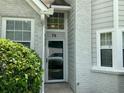 Home's front entrance featuring a storm door and an address marker at 76 Burbank Dr, Atlanta, GA 30314