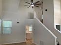 Open living room showcasing vaulted ceilings, stairway and a bright kitchen at 76 Burbank Dr, Atlanta, GA 30314