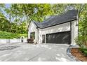 Spacious driveway leading to a modern home with a large garage and convenient gated access at 900 Edgewater Nw Dr, Atlanta, GA 30328