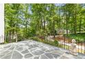 Relaxing stone patio surrounded by lush greenery offers tranquil views of the neighborhood at 900 Edgewater Nw Dr, Atlanta, GA 30328