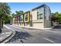 Street view of modern colorful townhomes with large windows and garages at 1360 Peter Haughton Nw Way, Atlanta, GA 30318