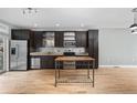 Modern kitchen with stainless steel appliances, island, and dark cabinetry at 1360 Peter Haughton Nw Way, Atlanta, GA 30318