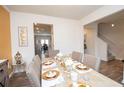 Dining room with a neutral color palette, decorative wall art and stylish table setting at 2718 Serena Way, Atlanta, GA 30331