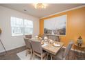 Formal dining room features hardwood floors, a decorative light fixture and large window at 2718 Serena Way, Atlanta, GA 30331