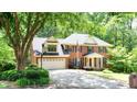 Spacious brick home with a two-car garage, basketball hoop, and well-kept landscaping at 1855 Vintage Dr, Snellville, GA 30078