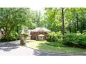 Beautiful two-story brick home with lush landscaping and a curved driveway, creating a welcoming entrance at 1855 Vintage Dr, Snellville, GA 30078