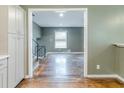 View of open floorplan with staircase and hardwood floors from the kitchen area at 2586 Williamsburg Dr, Decatur, GA 30034