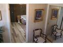 Hallway with patterned wallpaper, wood-look flooring, chair rail, and a mirrored closet at 2795 Dodson Lee Dr, East Point, GA 30344