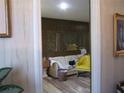 Living room showcasing wood-look flooring and patterned wallpaper at 2795 Dodson Lee Dr, East Point, GA 30344