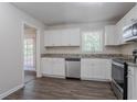 Modern kitchen featuring stainless steel appliances, white cabinets, and granite countertops at 3938 Emerald Springs Ct, Decatur, GA 30035