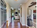 Bright foyer with hardwood floors, an open archway, and a view to the living room at 609 Turnbill Dr, Mcdonough, GA 30252