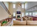 Spacious living room featuring a soaring ceiling, a fireplace, and an open layout at 609 Turnbill Dr, Mcdonough, GA 30252